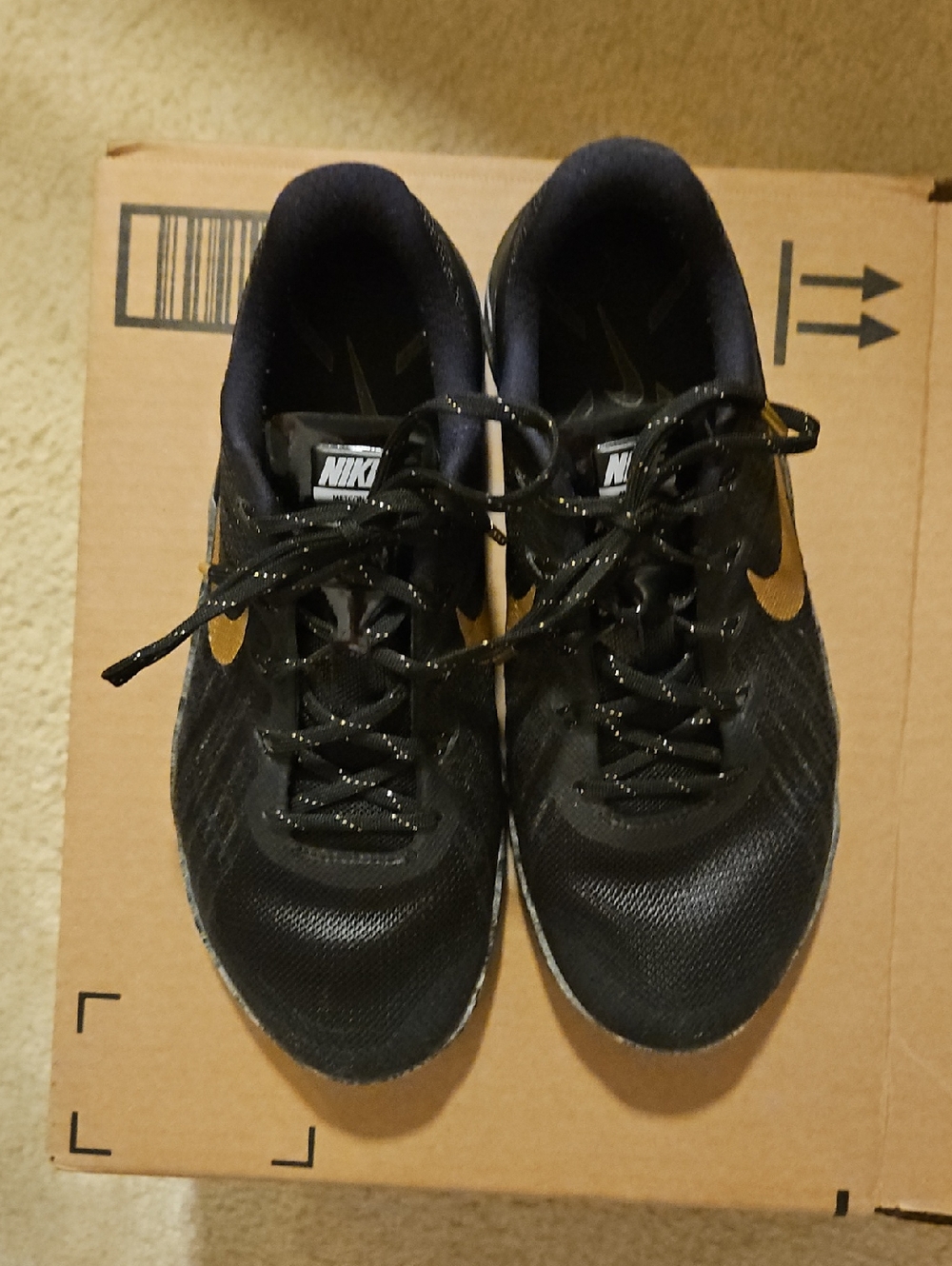 Nike Black Athletic Shoes with Gold Swoosh